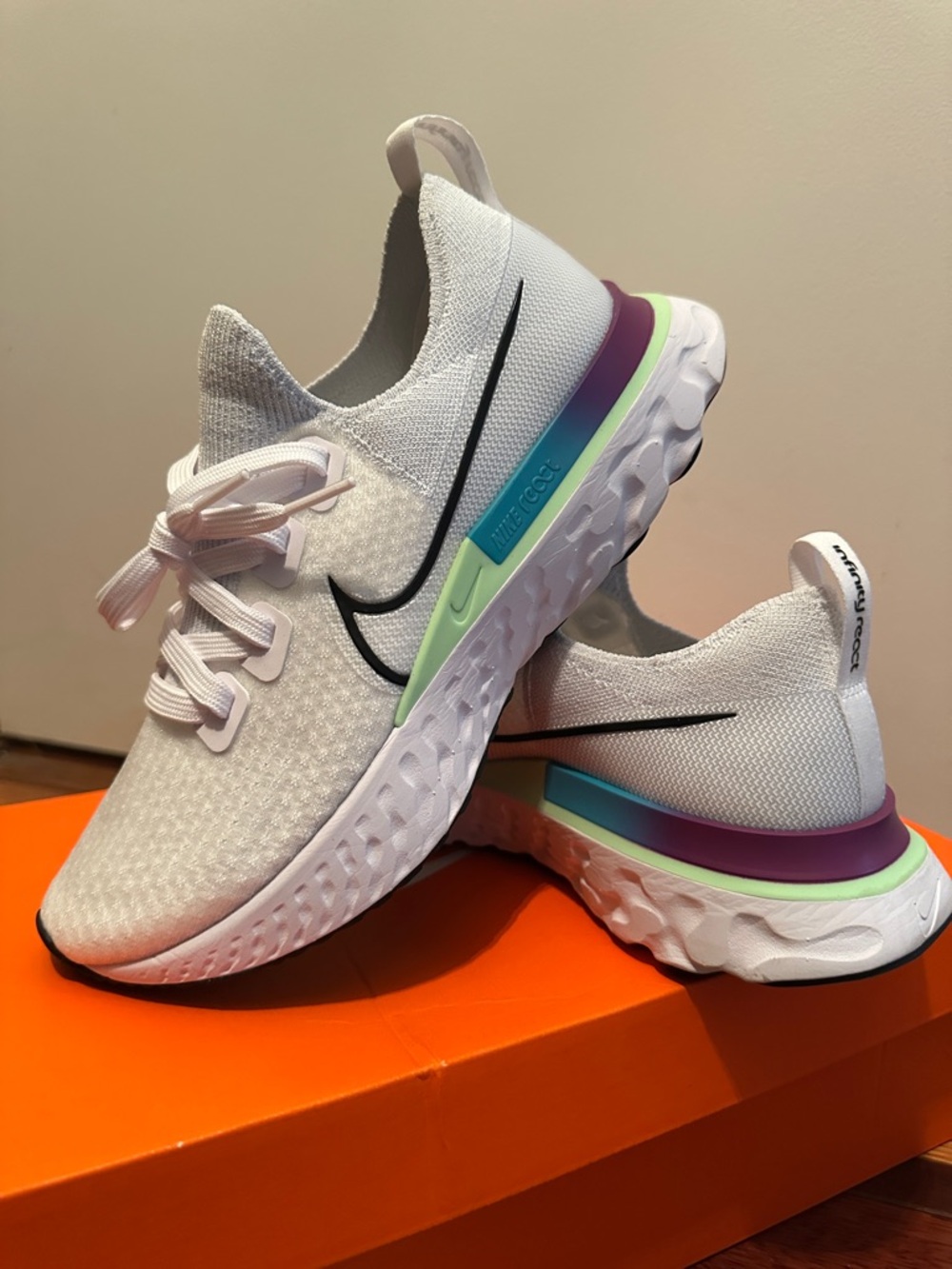 Nike Women's White Running Shoes with Black Swoosh and Pastel Accents